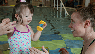 Young Patient in Therapy Pool with Therapist completing pediatric physical therapy