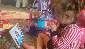 Child doing Speech & Language Therapy via telehealth on iPad